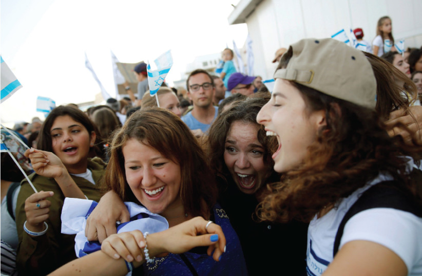 AN ‘OLAH HADASHA’ from North America (right) reacts as she is welcomed after landing at Ben-Gurion International Airport in 2016 (photo credit: BAZ RATNER/REUTERS)