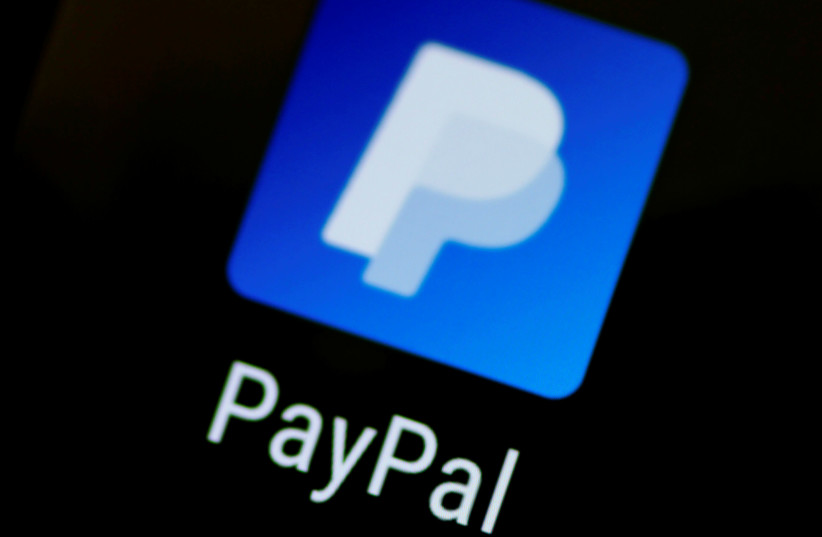The PayPal app logo seen on a mobile phone in this illustration photo (credit: REUTERS)