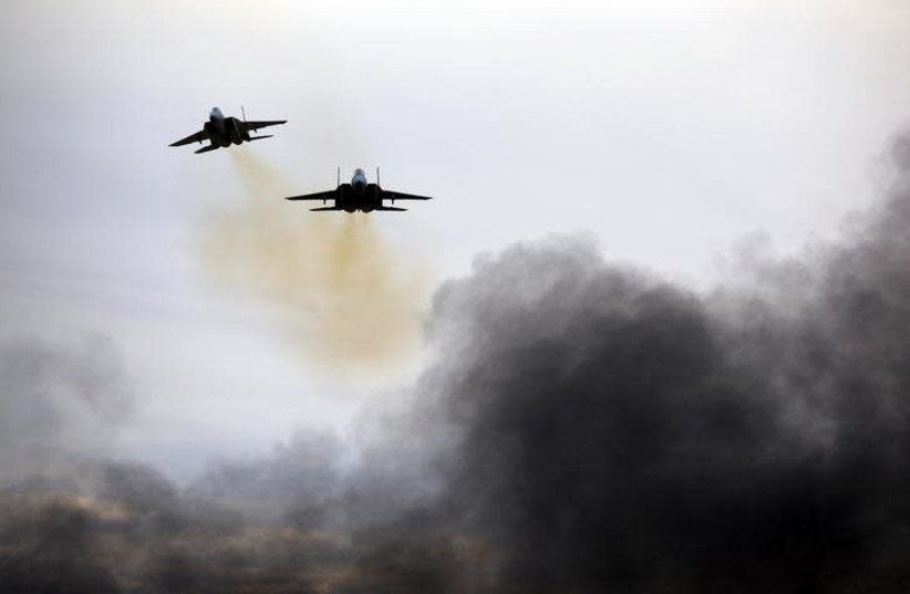 Israeli Air Force F15 planes fly during an aerial demonstration at a graduation ceremony for Israeli air force pilots at the Hatzerim air base in southern Israel, December 27, 2017. (photo credit: AMIR COHEN/REUTERS)