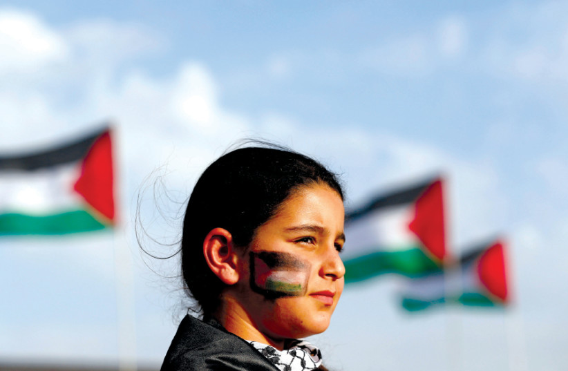 AN ISRAELI Arab girl takes part in a ‘Land Day’ rally, an annual commemoration of the killing of six Arab citizens by Israeli police in 1976 during protests against land confiscations in Deir Hanna in Galilee (photo credit: REUTERS)