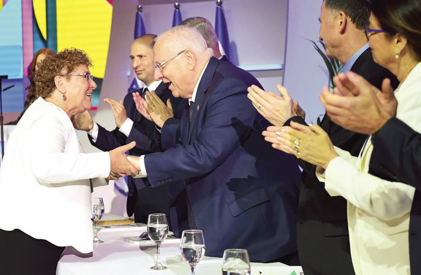 Miriam Peretz (L) shakes hands with Israel President Reuven Rivlin (R) during the Israel Prize ceremony in Jerusalem on Independence Day, April 19th, 2018. (photo credit: GPO)