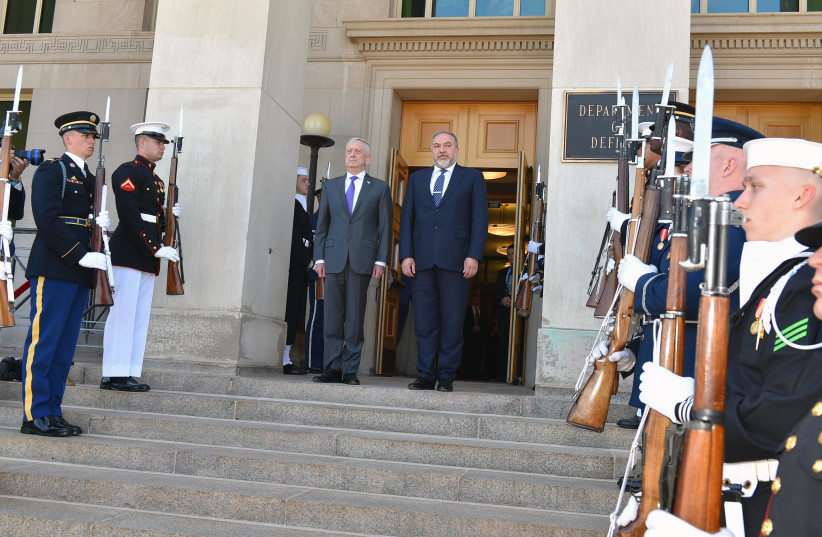 United States Secretary of Defense James Mattis (L) poses for a photo with Defense Minister Avigdor Liberman (R), April 26th, 2018.  (photo credit: DEFENSE MINISTRY/ARIEL HERMONI)