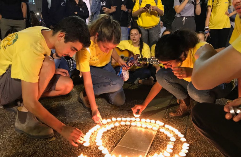 Dozens of teenagers gathering in circles Tel Aviv's Rabin Square, in memory of those killed in the Tzafit canyon flood disaster. (photo credit: AVSHALOM SASSONI/ MAARIV)