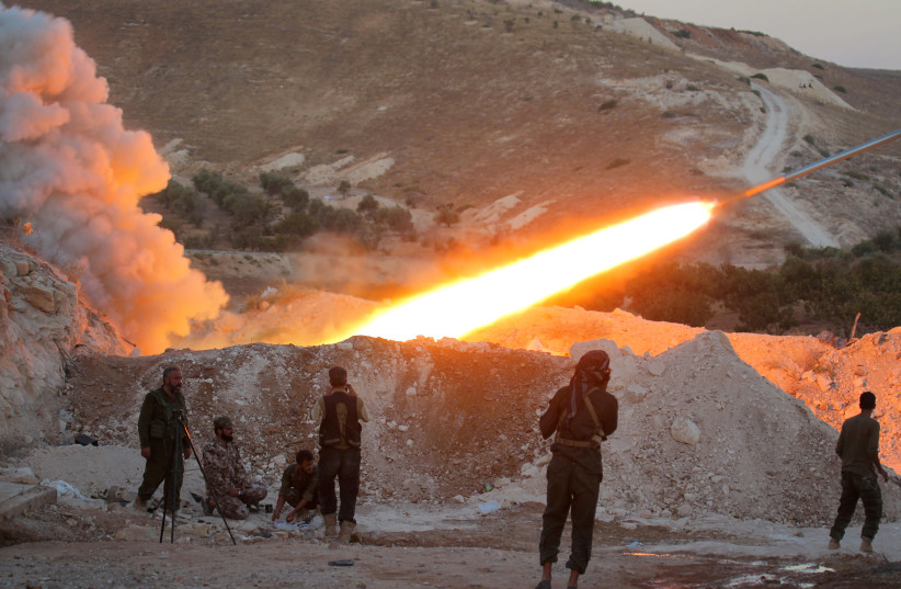 Free Syrian Army fighters launch a Grad rocket from Halfaya town in Hama province, towards forces loyal to Syria's President Bashar Assad stationed in Zein al-Abidin mountain, Syria September 4, 2016.  (photo credit: REUTERS/AMMAR ABDULLAH/FILE PHOTO)