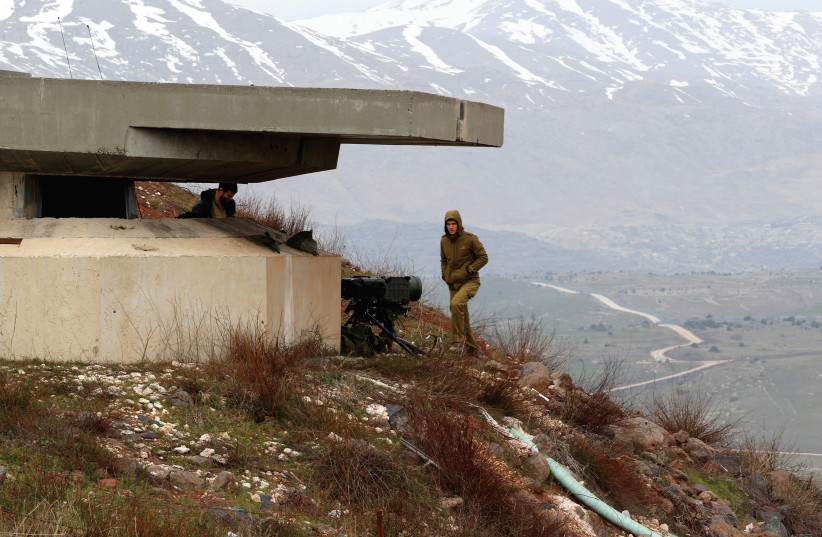 AN ISRAELI soldier stands next to the Golan border with Syria. Iran’s encroachments into Syria has led to increased tensions. (photo credit: REUTERS)