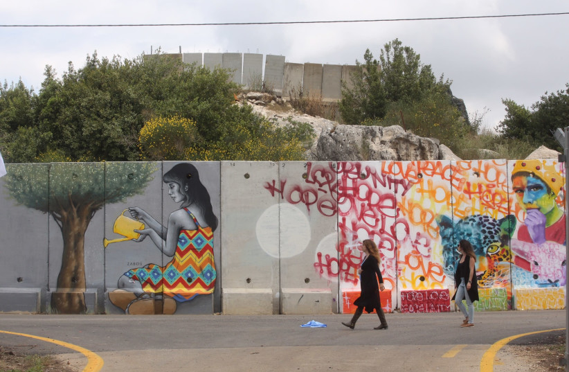 A dozen artists from around the world descended on the community of Shtula on Israel’s northern border to paint the security fence with Lebanon (photo credit: MARC ISRAEL SELLEM)