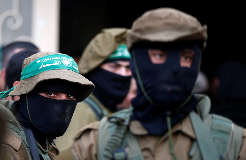 Hamas militants attend the funeral of members of Palestinian security forces loyal to Hamas, in the central Gaza Strip March 22, 2018. (photo credit: REUTERS/MOHAMMED SALEM)