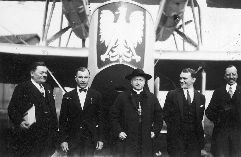 A photo from 1929 at a dedication of a plane purchased by the Polish consulates. Visible: Cardinal August Hlond (in the center), American Polonia activist Adamkiewicz (1st from left), Lieutenant Reserve Pilot from PLL "Lot" Włodzimierz Klisz (2nd from the left), captain pilot from the 3rd Air Regime (photo credit: Wikimedia Commons)