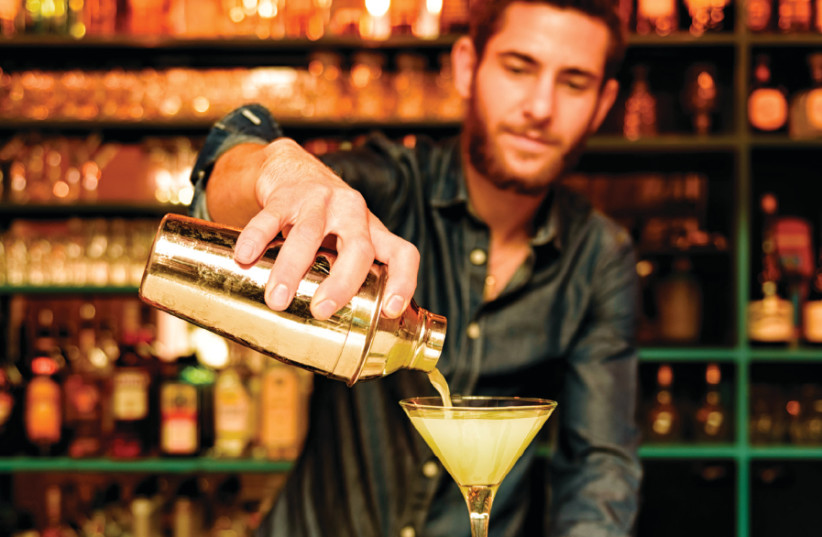Gil Barnea pours a martini (photo credit: NIR ROITMAN/TAP & TAIL)