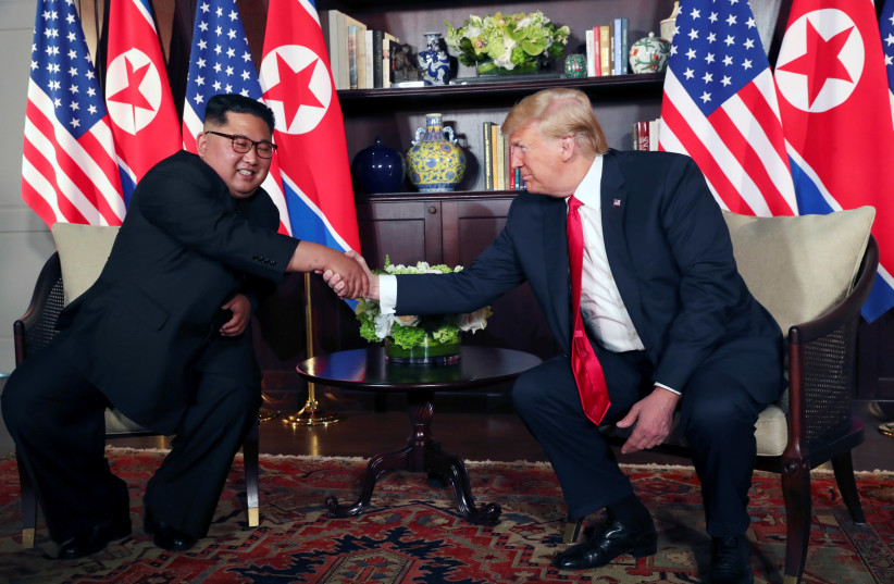 U.S. President Donald Trump shakes hands with North Korea's leader Kim Jong Un before their bilateral meeting at the Capella Hotel on Sentosa island in Singapore June 12, 2018. (photo credit: JONATHAN ERNST / REUTERS)