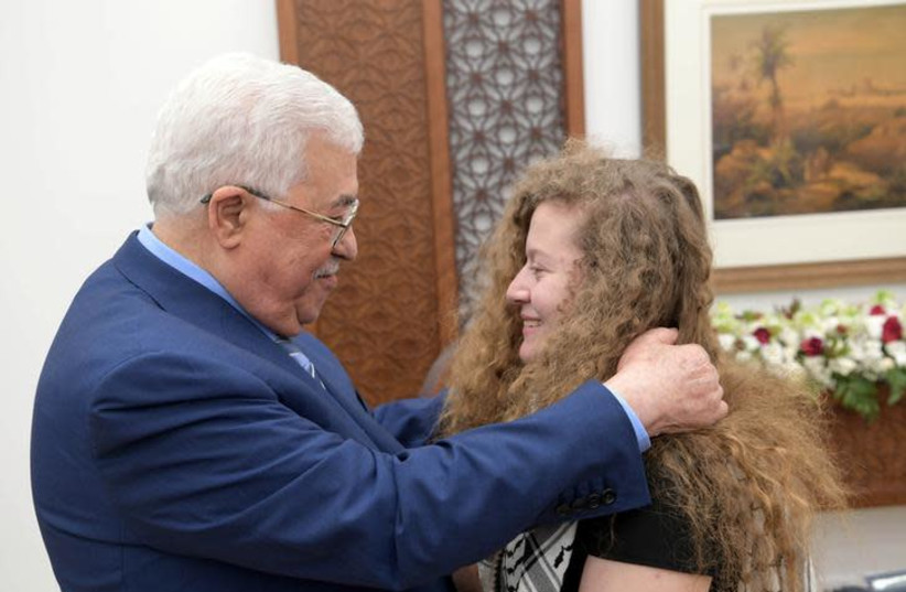 Palestinian President Mahmoud Abbas meets with freed Palestinian teenager Ahed Tamimi after she was released from an Israeli prison, in Ramallah in the West Bank July 29, 2018 (credit: PALESTINIAN PRESIDENT OFFICE (PPO)/HANDOUT VIA REUTERS)