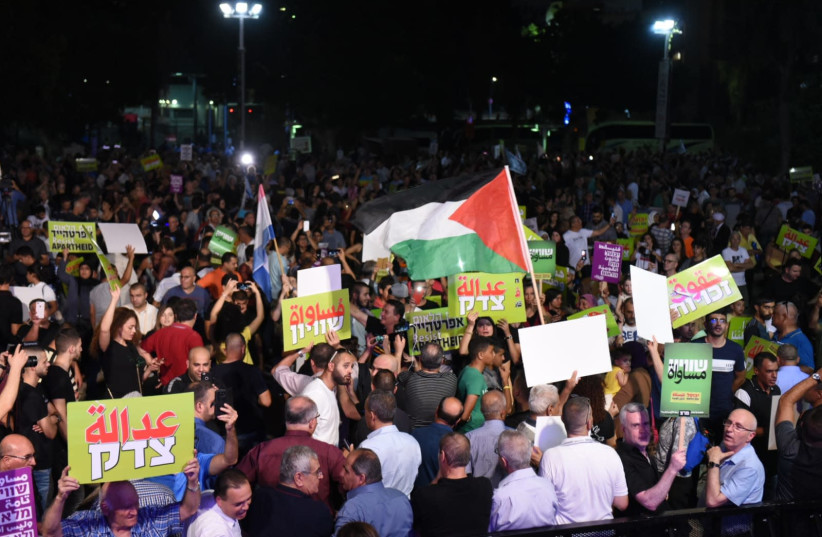 Palestinian flags flutter at a protest against the Nation-State Law in Rabin Square, Tel Aviv, August 11th, 2018 (photo credit: KOBI RICHTER/TPS)