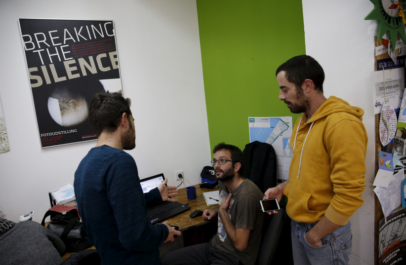 Employees work at the offices of "Breaking the Silence" in Tel Aviv, Israel, December 16, 2015 (photo credit: BAZ RATNER/REUTERS)