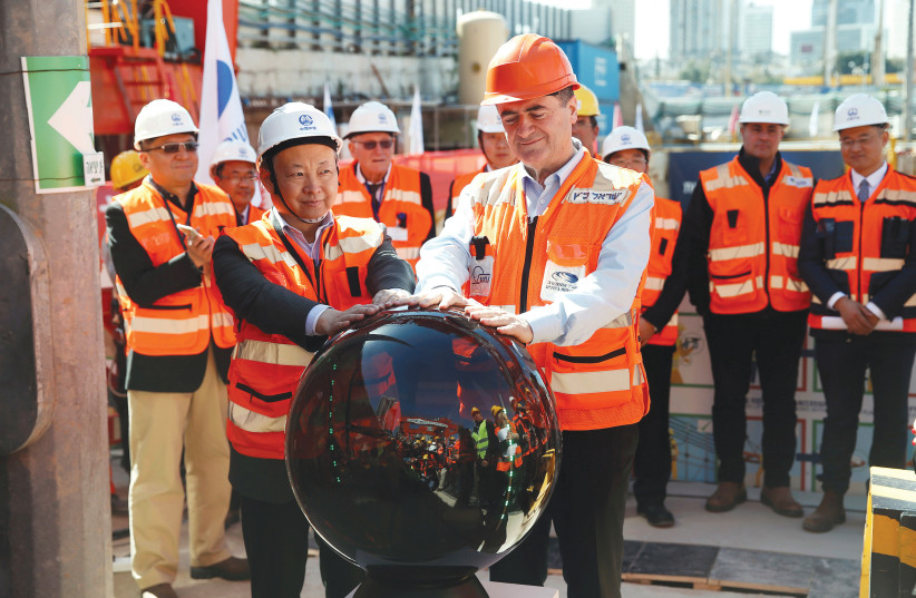TRANSPORTATION MINISTER Israel Katz (right) and Ambassador Zhan Yongxin of China take part in an event marking the beginning of underground construction work of the light rail, using a Tunnel Boring Machine (TBM) in Tel Aviv, February 2018 (photo credit: REUTERS)