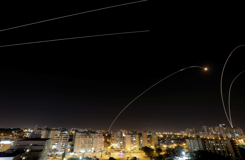 A general view of the Israeli city of Ashkelon, as an Iron Dome anti-missile fires near the Israeli side of the Israel-Gaza border, November 12, 2018. (photo credit: REUTERS/AMIR COHEN)