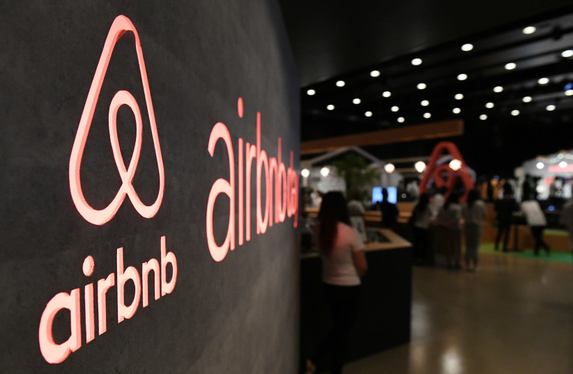 The US rental site Airbnb logo is displayed during the company's press conference in Tokyo on June 14, 2018 (credit: TOSHIFUMI KITAMURA / AFP)