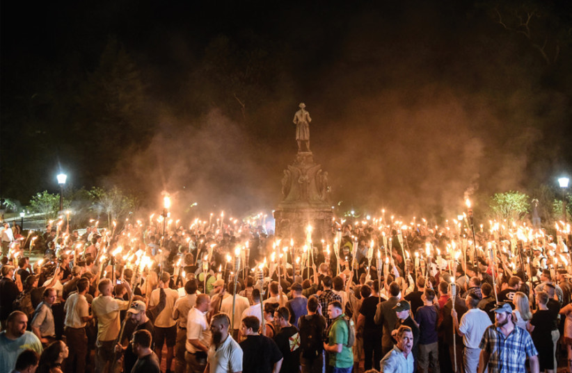 American white nationalists march at the University of Virginia ahead of the Unite the Right Rally in Charlottesville, Virginia, on August 11, 2017. In Charlottesville, antisemitic marchers shouted, 'Jews won’t replace us' (credit: STEPHANIE KEITH/REUTERS)