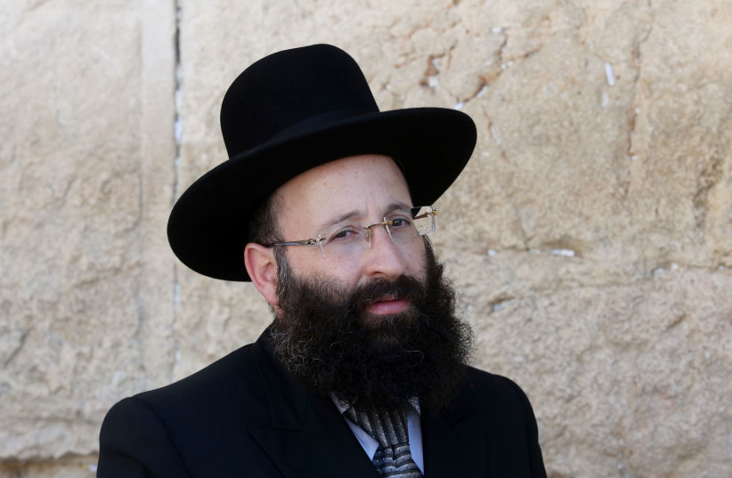 Rabbi Shmuel Rabinowitz, Rabbi of the Western Wall, poses for a photo in front of the holy site (credit: MARC ISRAEL SELLEM/THE JERUSALEM POST)