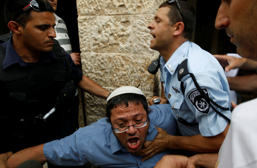 Far-right wing activist Itamar Ben-Gvir is detained by Israeli police. (credit: RONEN ZVULUN / REUTERS)