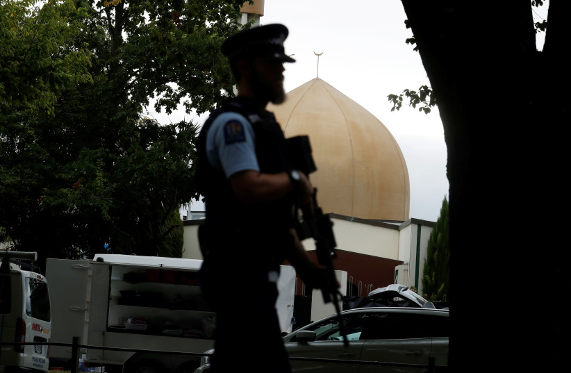 A police officer patrols outside Masjid Al Noor mosque after Friday's mosque attacks in Christchurch, New Zealand, March 16, 2019.  (photo credit: REUTERS/JORGE SILVA)