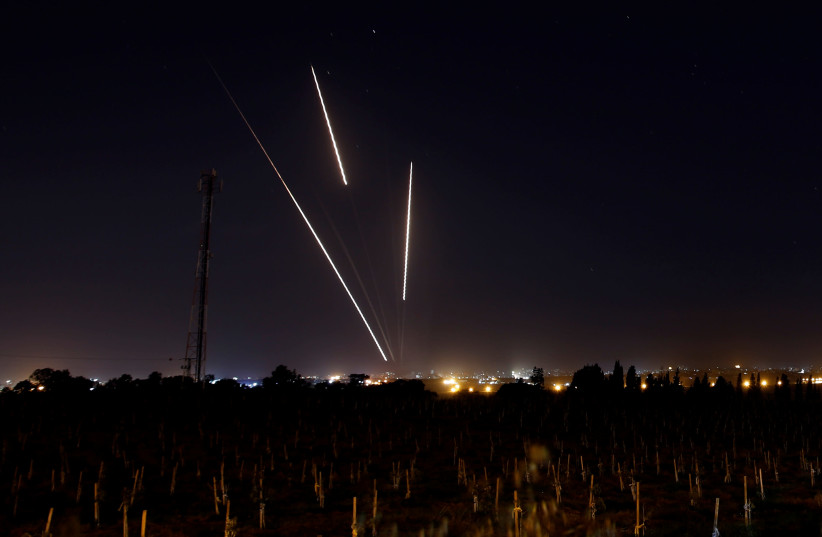 Streaks of light are pictured as rockets are launched from the Gaza Strip towards Israel, as seen from the Israeli side of the border March 25, 2019 (photo credit: REUTERS/AMIR COHEN)