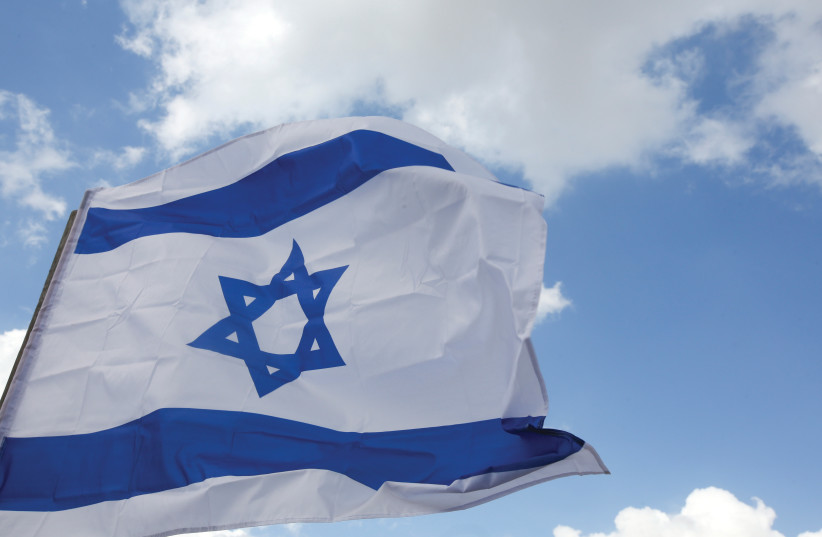 An Israeli flag [Ilustrative] (credit: MARC ISRAEL SELLEM/THE JERUSALEM POST)