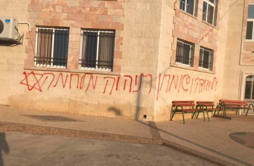 Graffiti in Hebrew sprayed in Deir Istiya, 'over Judea and Samaria there will be a war.'  (photo credit: VILLAGE COUNCIL OF DEIR ISTIYA)