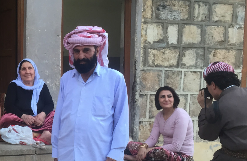 Several Yazidis pose for a photo in Lalish in 2015.  (photo credit: REUTERS)