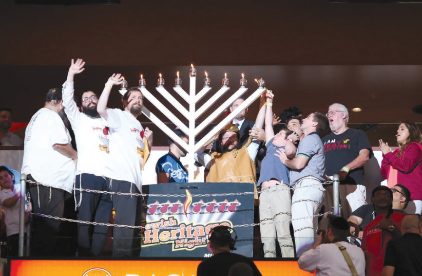 JOYOUS HANUKKAH: Lighting the menorah at Miami’s Rok Family Shul – Chabad Downtown Jewish Center. (credit: ROK FAMILY SHUL)