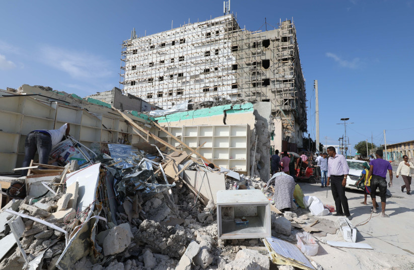 A general view shows people at the scene of a suicide car explosion at a check point near Somali Parliament building in Mogadishu, Somalia June 15, 2019 (credit: FEISAL OMAR/REUTERS)