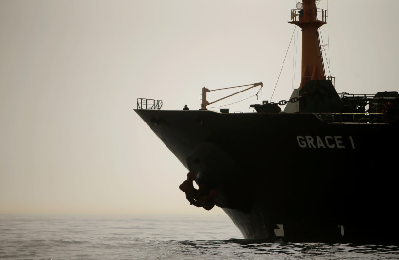A crew member of the Iranian oil tanker Grace 1 is seen on the bow as it sits anchored after it was seized earlier this month by British Royal Marines off the coast of the British Mediterranean territory (photo credit: JON NAZCA/ REUTERS)