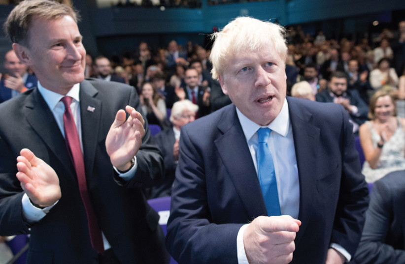 BRITISH SECRETARY of State for Foreign and Commonwealth Affairs Jeremy Hunt (left) congratulates Boris Johnson after it was announced that Johnson was the new Conservative Party leader and would become the next prime minister, at the Queen Elizabeth II Centre in London on July 23. (photo credit: STEFAN ROUSSEAU/REUTERS)