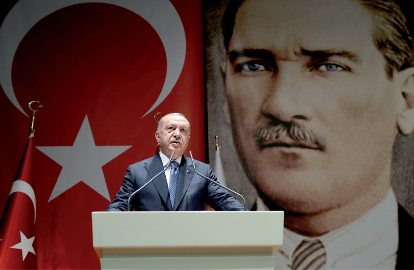 Turkish President Reçep Tayyip Erdoğan addresses a meeting of his ruling AK Party in Ankara on July 26 (photo credit: CEM OKSUZ/TURKISH PRESIDENTIAL PRESS OFFICE/HANDOUT VIA REUTERS)