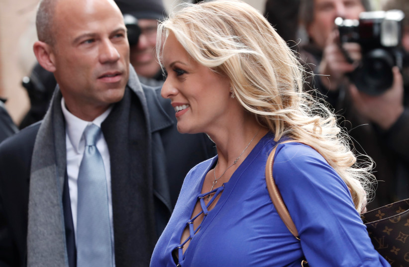 Adult-film actress Stephanie Clifford, also known as Stormy Daniels, arrives with her attorney Michael Avenatti (L) at ABC studios to appear on The View talk show in New York City, New York, U.S. (credit: REUTERS/MIKE SEGAR)