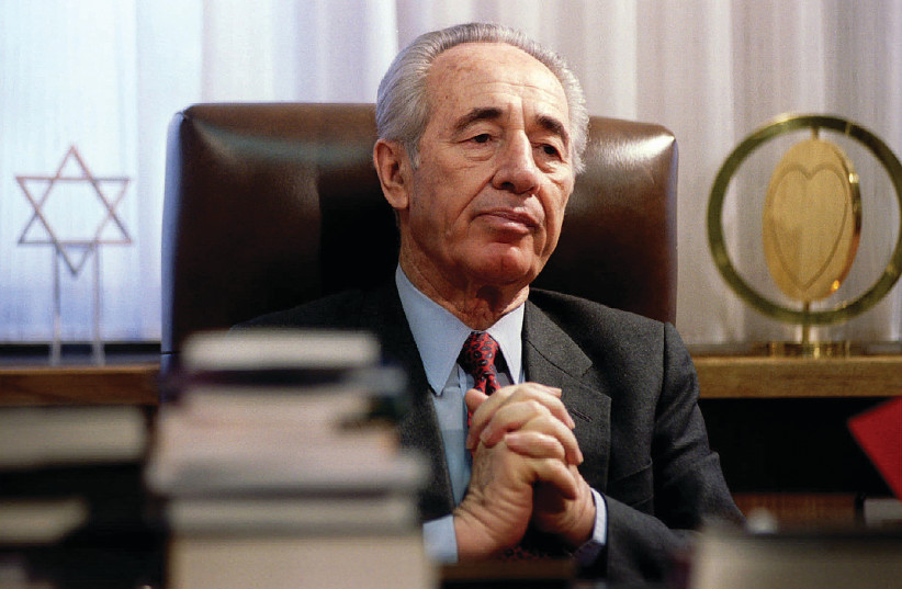 THE LATE Shimon Peres at his desk in 1994.  (credit: REUTERS)