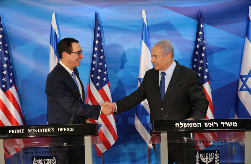 U.S. Treasury Secretary Steven Mnuchin shakes hands with Israeli Prime Minister Benjamin Netanyahu, who urged him to crank up pressure on Iran at a press conference in Jerusalem (photo credit: AMIT SHABI/YEDIOTH ACHRONOTH/POOL)