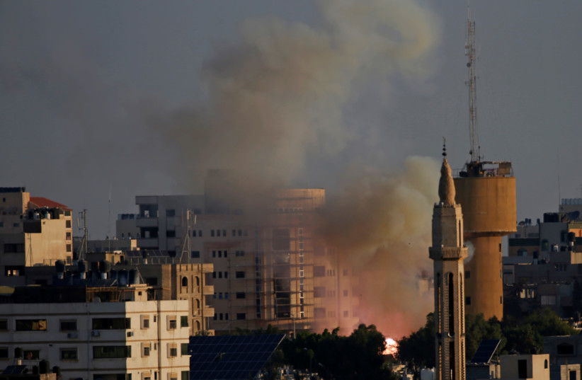 Flame and smoke are seen following an explosion in Gaza City November 12, 2019 (photo credit: REUTERS/MOHAMMED SALEM)