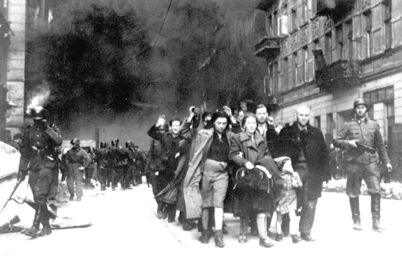 Captured Jews pulled out of Warsaw Ghetto bunkers are led by German Waffen SS soldiers to 'Umschlagplatz,' the assembly point for deportation.  (credit: Wikimedia Commons)
