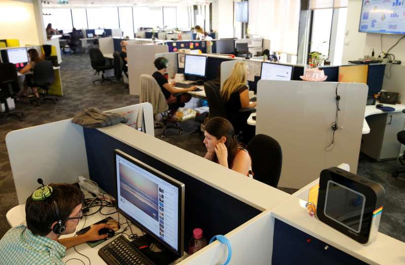 Employees work at Internet data firm SimilarWeb at their offices in Tel Aviv, Israel July 4, 2016 (credit: BAZ RATNER/REUTERS)