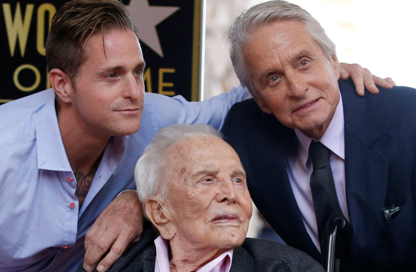Actor Michael Douglas poses with his father Kirk Douglas and son Cameron Douglas during the unveiling of his star on the Hollywood Walk of Fame in Los Angeles, California, U.S., November 6, 2018 (photo credit: MARIO ANZUONI/REUTERS)