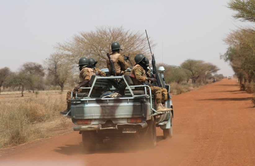 FILE PHOTO: Soldiers from Burkina Faso patrol on the road of Gorgadji in the Sahel area of Burkina Faso, March 3, 2019. (photo credit: LUC GNAGO/REUTERS)