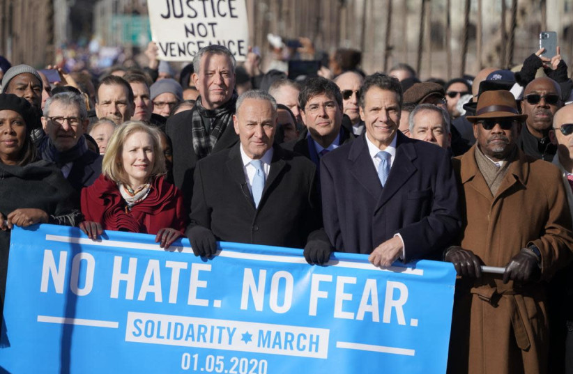 (From right to left) Congressman Gregory Meeks; Governor Andrew Cuomo, UJA CEO Eric Goldstein; Senator Chuck Schumer; Mayor Bill DeBlasio; US Senator Kirsten Gillibrand; JCRC CEO Michael Miller; and New York State Attorney General Letitia James march against antisemitism across the Brooklyn Bridge. (credit: COURTESY JAKE ASNER - UJA-FEDERATION OF NEW YORK)