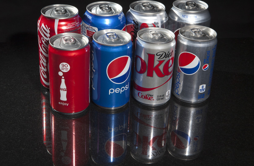 Regular and mini cans of Coke and Pepsi are pictured in this photo illustration in New York August 5, 2014. REUTERS/Carlo Allegri  (credit: REUTERS)