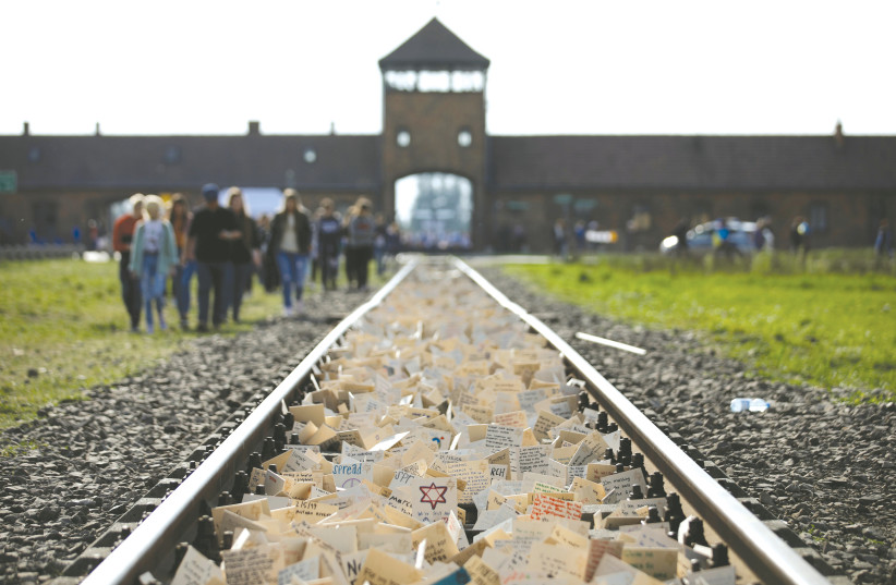 ‘March of the Living’ participants leave notes on the tracks leading to the former German Nazi Auschwitz concentration camp near Oswiecim, Poland, May 2, 2019. (credit: REUTERS/KACPER PEMPEL)