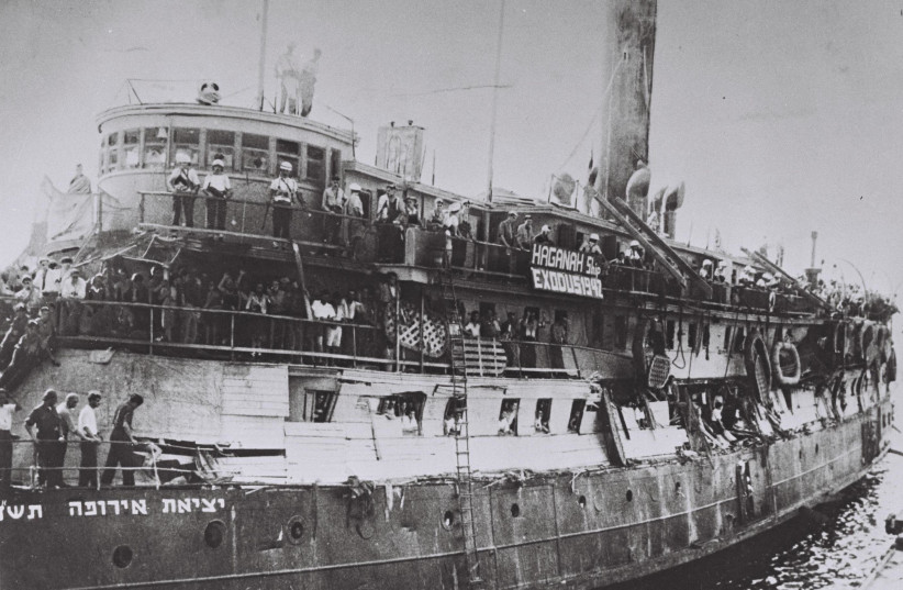 The 'EXODUS' ship following the Britsih takeover, with damage to its makeshift barriers. The banner reads, 'Haganah Ship Exodus 1947.' (credit: Wikimedia Commons)