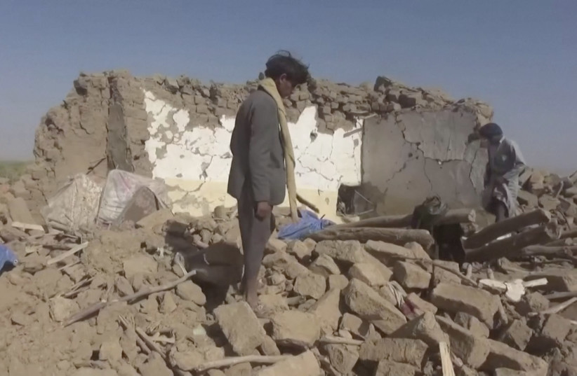 People rummage through rubble after an air strike in Al-Jawf province, Yemen, February 15, 2020 in this still image taken from a video (credit: HOUTHI MEDIA CENTER VIA REUTERS)