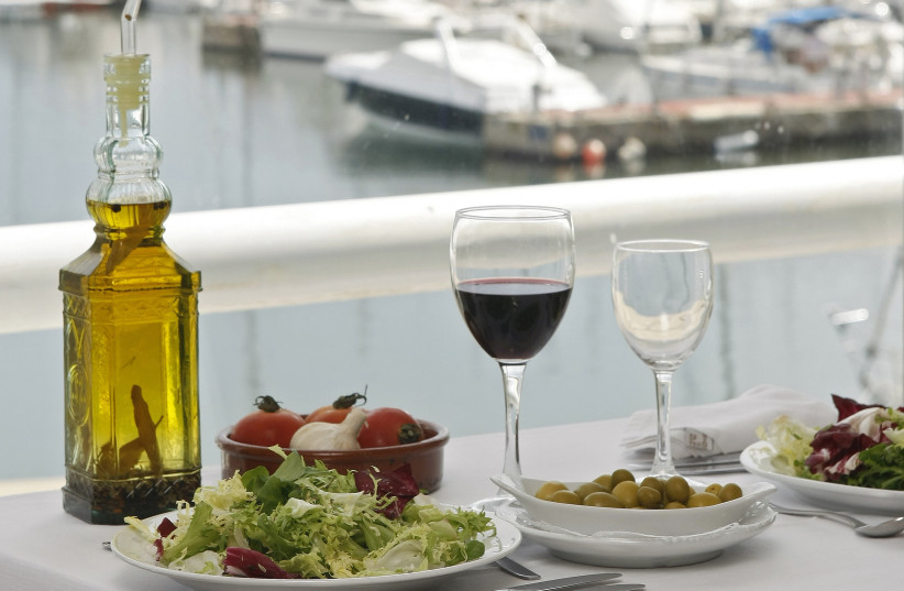 Food is seen on a table at a restaurant at the port of El Masnou, near Barcelona May 16, 2008. The Spanish government is leading a bid to persuade UNESCO to put the Mediterranean diet on the world heritage list. (photo credit: REUTERS)