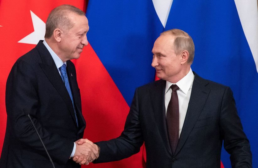 Russian President Vladimir Putin and Turkish President Tayyip Erdogan shake hands during a news conference following their talks in Moscow, Russia March 5, 2020.  (credit: PAVEL GOLOVKIN/POOL VIA REUTERS)