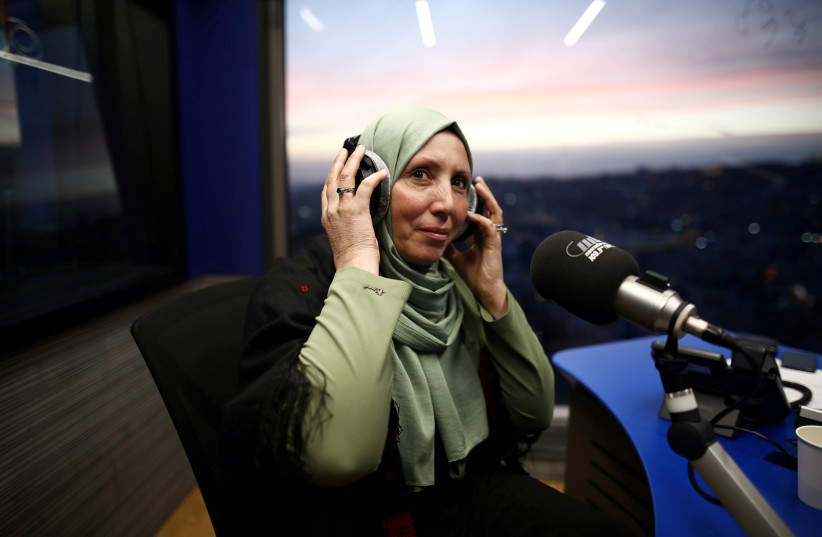 Iman Yassin Khatib, poised to become the first lawmaker in Israel's history to wear a hijab or head scarf, which she does as a Muslim, following results of her Arab Joint List party in Israel's election, participates in an interview in a radio show in Naz (credit: REUTERS)