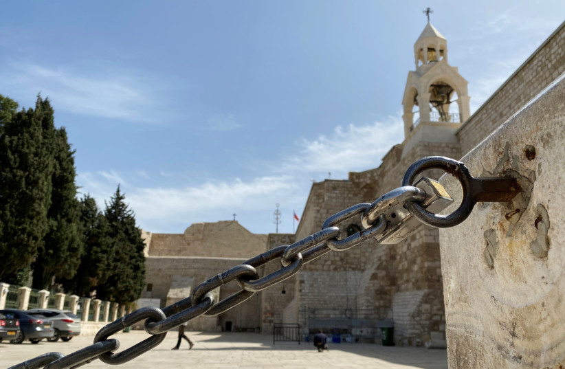 An entrance of the Church of the Nativity is seen locked amid coronavirus precautions, in Bethlehem in the Israeli-occupied West Bank March 11, 2020 (credit: REUTERS/MUSTAFA GANEYEH)